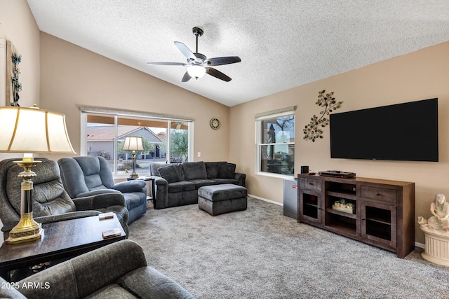 carpeted living room featuring ceiling fan, vaulted ceiling, and a textured ceiling