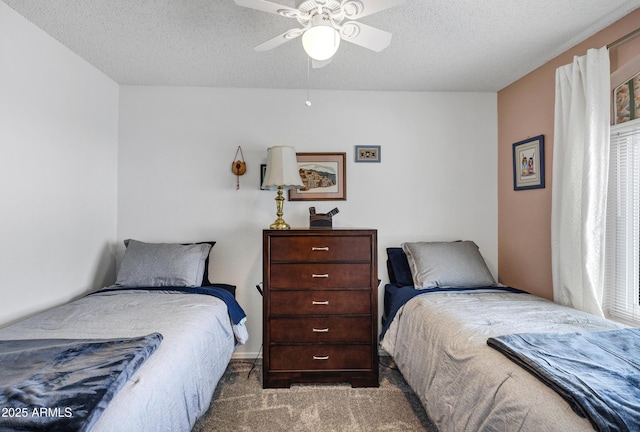 carpeted bedroom with a textured ceiling and ceiling fan