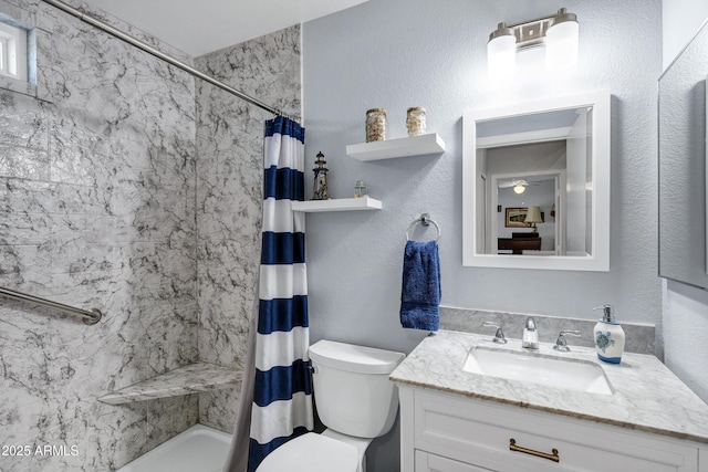 bathroom with vanity, curtained shower, and toilet