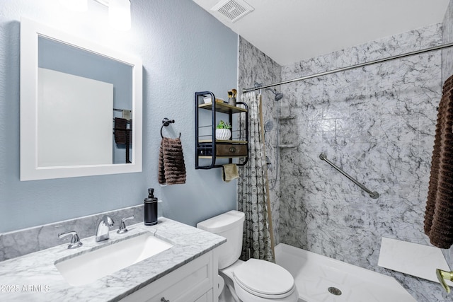 bathroom with vanity, toilet, and walk in shower