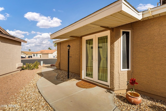 entrance to property featuring french doors and a patio area