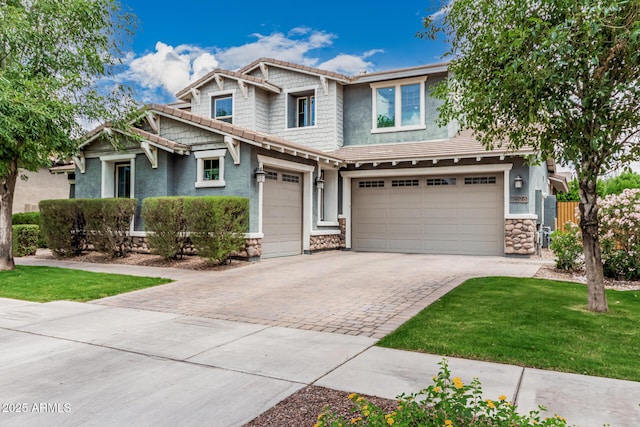 7528 E Peralta Ave, Mesa, AZ 85212 - craftsman-style home with stone siding, decorative driveway, an attached garage, and a tile roof