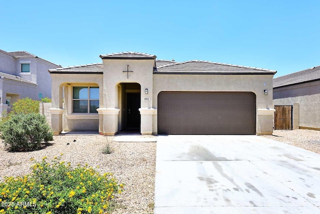 29932 N Paloverde Dr, Florence, AZ 85132 - mediterranean / spanish-style home with an attached garage, driveway, stucco siding, and a tiled roof