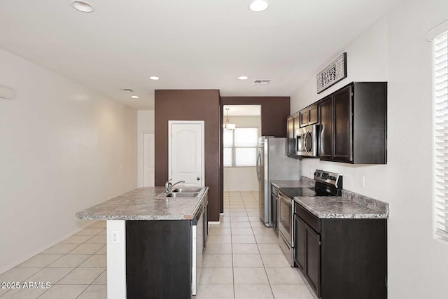 29932 N Paloverde Dr, Florence, AZ 85132 - kitchen featuring stainless steel appliances, a sink, a kitchen island with sink, light tile patterned flooring, and recessed lighting