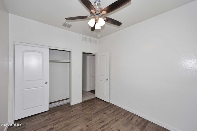 29932 N Paloverde Dr, Florence, AZ 85132 - unfurnished bedroom featuring wood finished floors, a closet, baseboards, and a ceiling fan