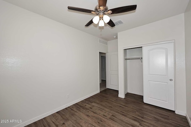 29932 N Paloverde Dr, Florence, AZ 85132 - unfurnished bedroom with dark wood-type flooring, baseboards, a closet, and ceiling fan