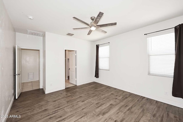 29932 N Paloverde Dr, Florence, AZ 85132 - unfurnished bedroom with wood finished floors, attic access, baseboards, and a ceiling fan