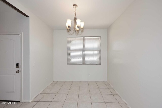 29932 N Paloverde Dr, Florence, AZ 85132 - empty room featuring a chandelier, light tile patterned floors, and baseboards