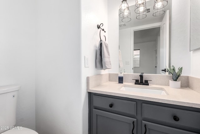 bathroom featuring vanity and toilet