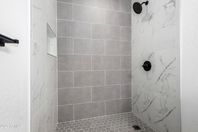 bathroom with a tile shower