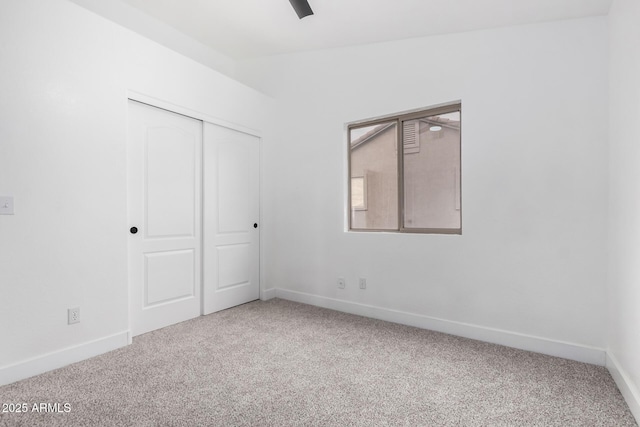 unfurnished bedroom with carpet flooring, vaulted ceiling, and a closet