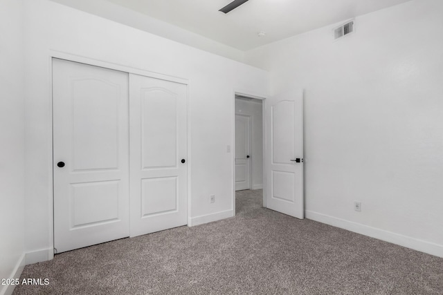 unfurnished bedroom with carpet flooring and a closet