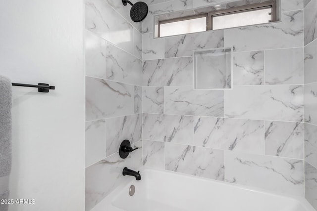 bathroom featuring tiled shower / bath