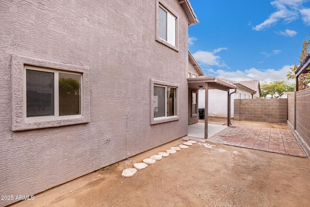 view of side of property featuring a patio