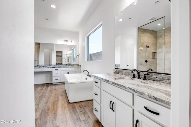 bathroom with vanity, hardwood / wood-style floors, and separate shower and tub