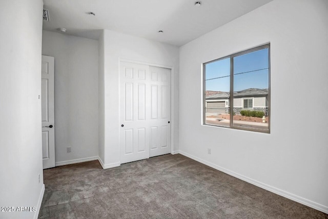 unfurnished bedroom with a closet and carpet