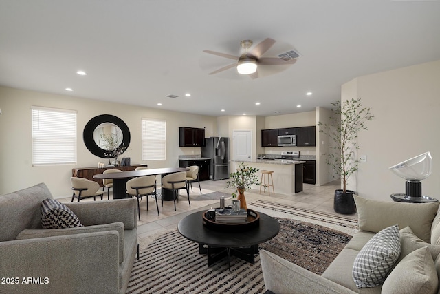 living room featuring recessed lighting, visible vents, ceiling fan, and light tile patterned flooring