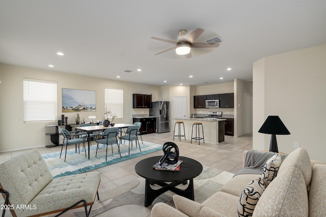 living room with light tile patterned floors, ceiling fan, and recessed lighting