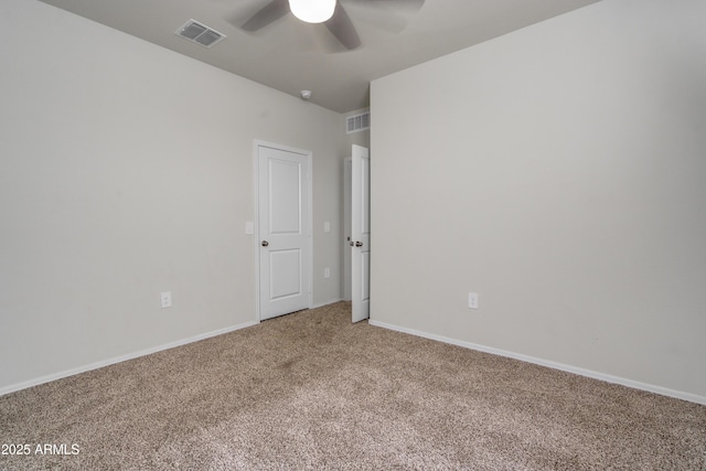 unfurnished room featuring baseboards, visible vents, and carpet flooring