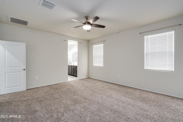 unfurnished room featuring ceiling fan, baseboards, visible vents, and light colored carpet