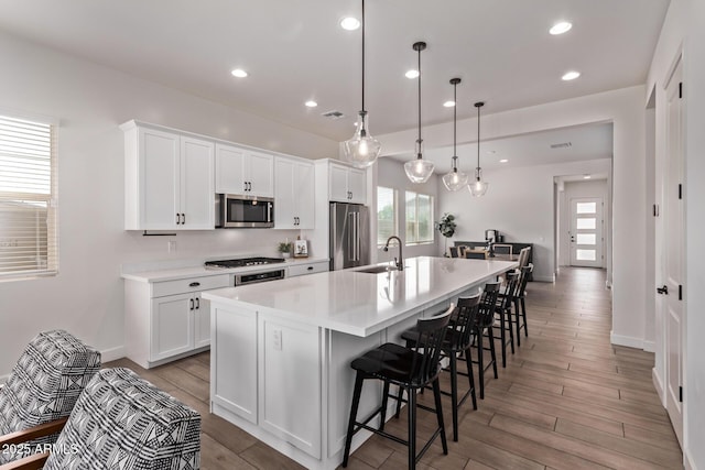 3031 S Valerie Dr, Chandler, AZ 85286 - kitchen featuring stainless steel appliances, a spacious island, white cabinetry, and a sink
