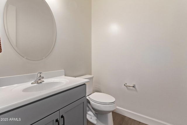 3031 S Valerie Dr, Chandler, AZ 85286 - half bath with vanity, baseboards, wood finished floors, and toilet