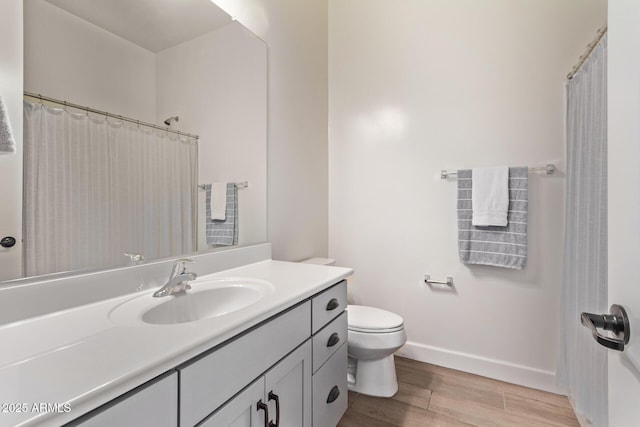 3031 S Valerie Dr, Chandler, AZ 85286 - bathroom with vanity, baseboards, wood finished floors, and toilet