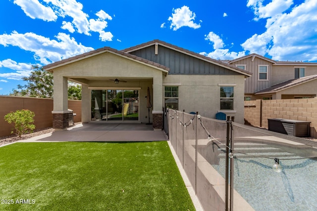 3031 S Valerie Dr, Chandler, AZ 85286 - rear view of house featuring a fenced backyard, a ceiling fan, board and batten siding, a patio area, and a yard