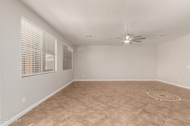 empty room featuring visible vents, ceiling fan, a textured ceiling, and baseboards