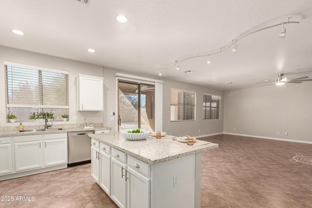 kitchen featuring a sink, white cabinetry, open floor plan, a center island, and dishwasher