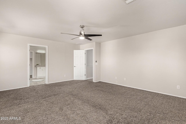 unfurnished bedroom featuring carpet floors, connected bathroom, a ceiling fan, and baseboards