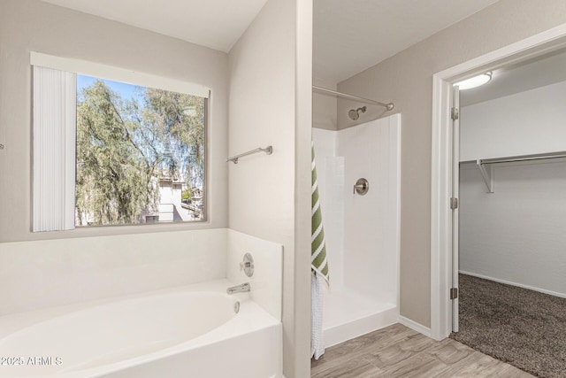 bathroom with a stall shower and a spacious closet