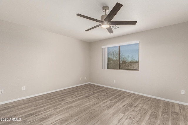 unfurnished room with light wood-type flooring, baseboards, and visible vents