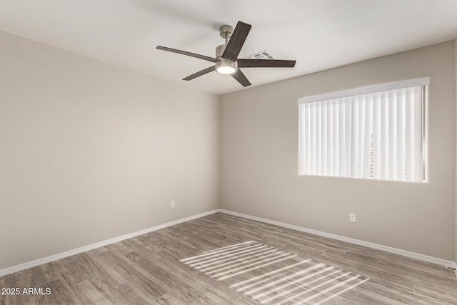 unfurnished room featuring visible vents, a ceiling fan, light wood-style flooring, and baseboards