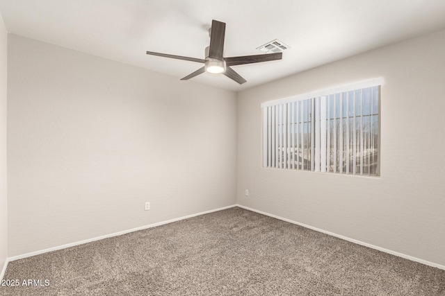 unfurnished room with ceiling fan, carpet flooring, visible vents, and baseboards