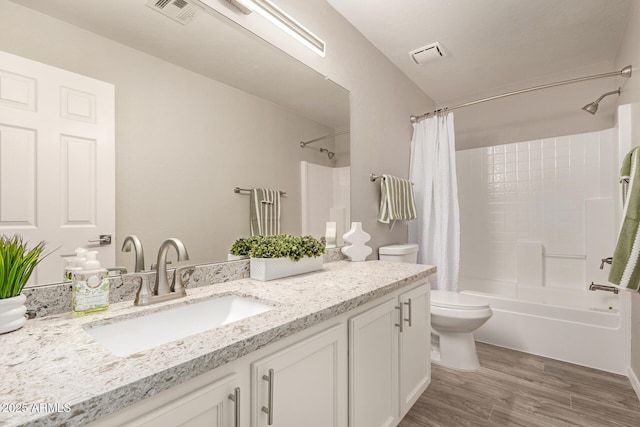 full bathroom featuring visible vents, vanity, toilet, and wood finished floors