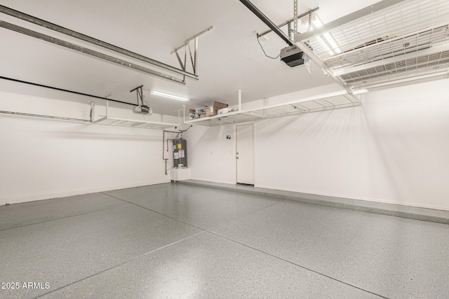 garage featuring a garage door opener, electric water heater, and baseboards