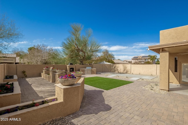 view of patio / terrace featuring a fenced backyard and an outdoor kitchen