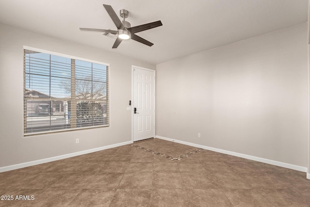 unfurnished room with ceiling fan, visible vents, and baseboards