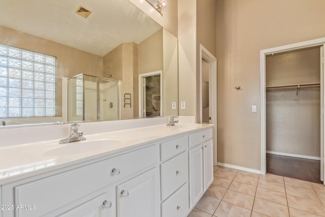 bathroom featuring a shower stall, visible vents, a sink, and tile patterned floors