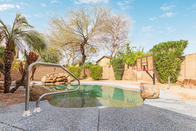 view of swimming pool with a fenced backyard