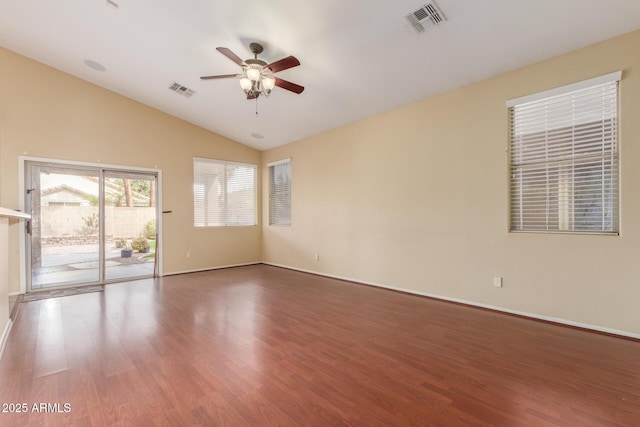 unfurnished room featuring lofted ceiling, ceiling fan, visible vents, and wood finished floors