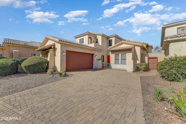 mediterranean / spanish house with a garage