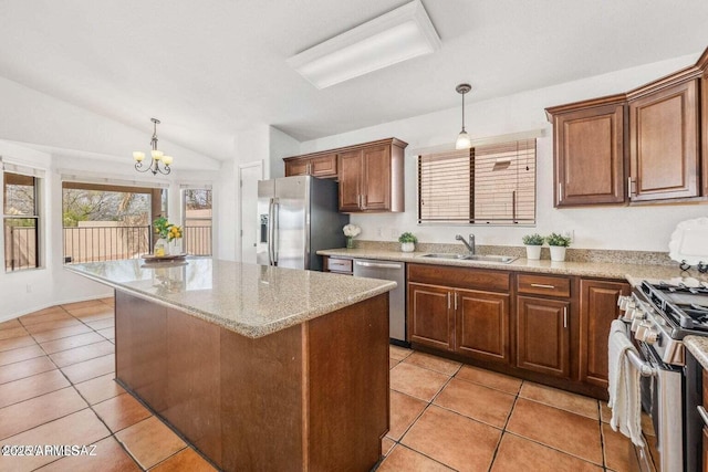kitchen featuring a sink, light tile patterned floors, appliances with stainless steel finishes, and a notable chandelier