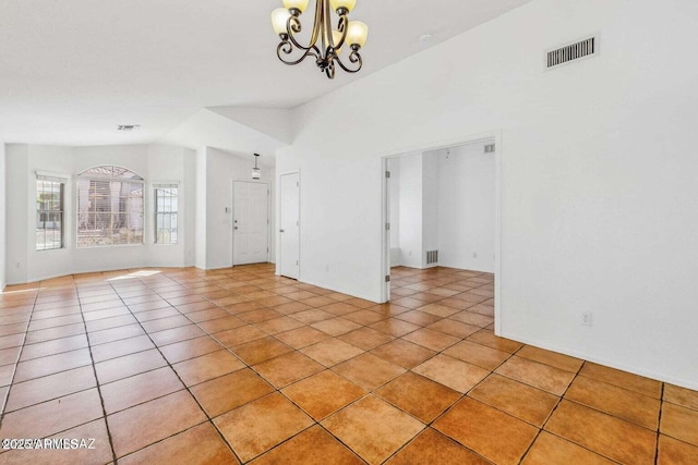 unfurnished room with an inviting chandelier, vaulted ceiling, visible vents, and light tile patterned floors