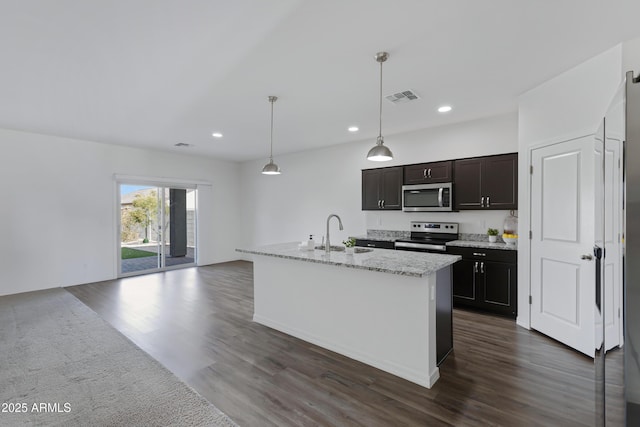 kitchen with stainless steel appliances, decorative light fixtures, a kitchen island with sink, and sink