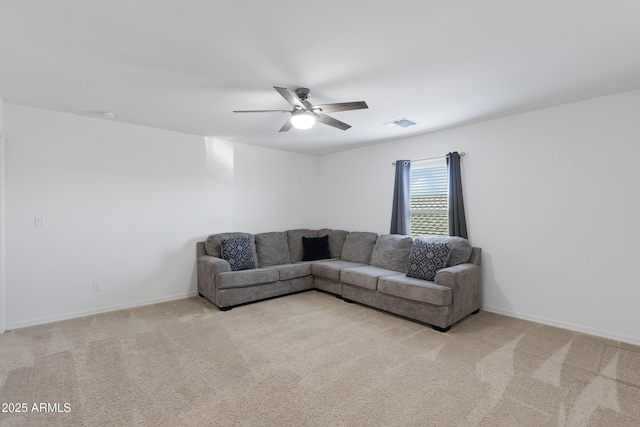 carpeted living room with ceiling fan