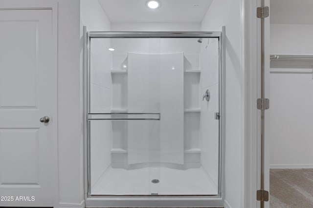 bathroom featuring a shower with door