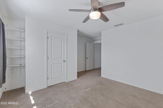 unfurnished bedroom featuring ceiling fan and light colored carpet