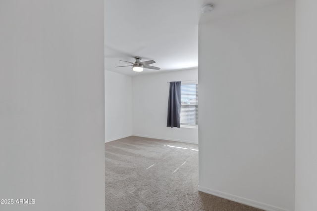 carpeted spare room with ceiling fan